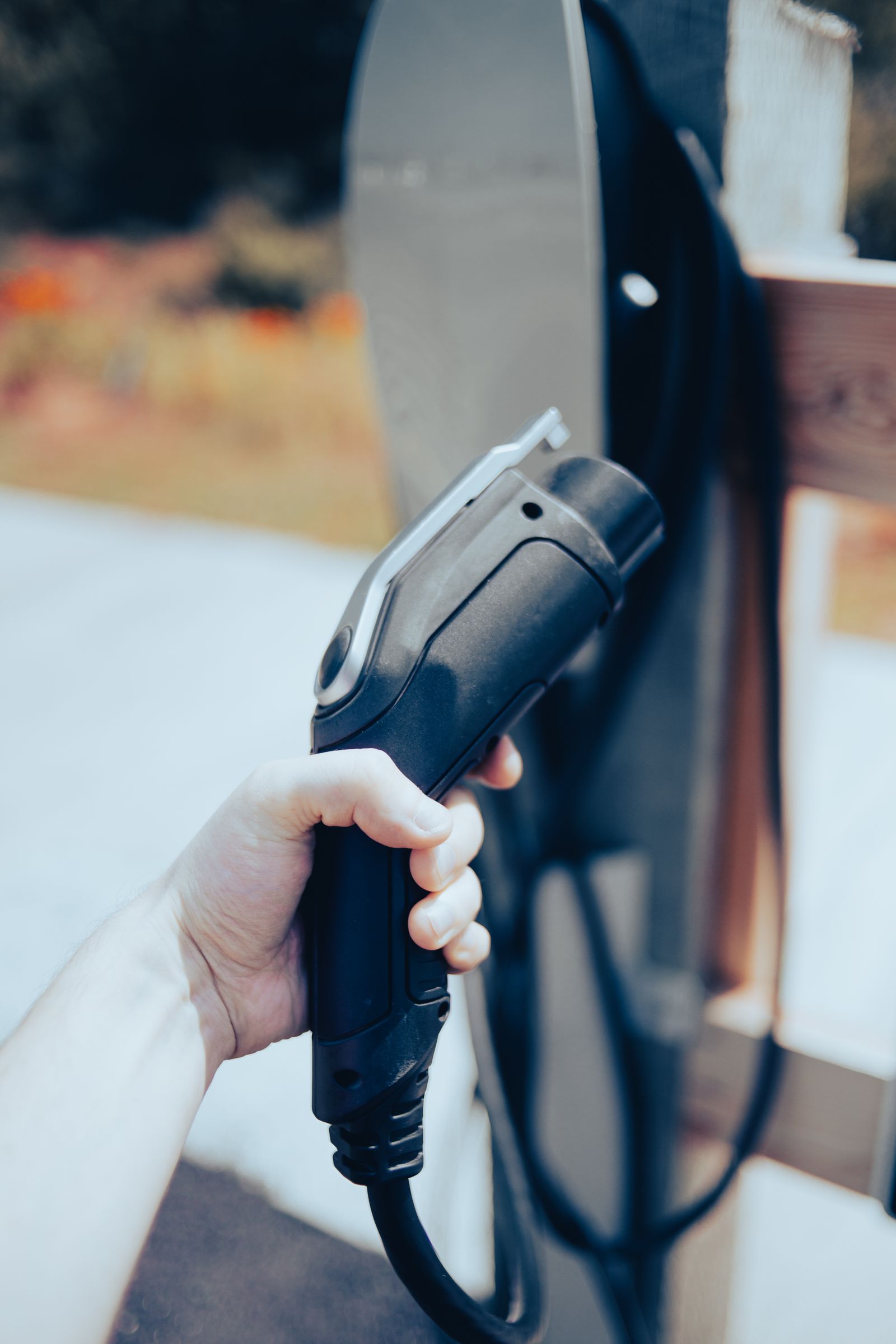 Hand holding an electric vehicle charging cable